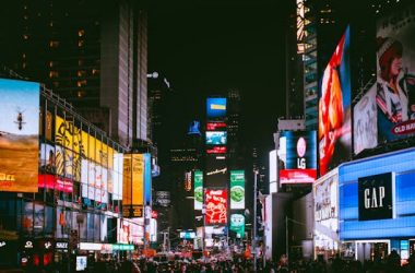 Crowd of People on Street With City Lights